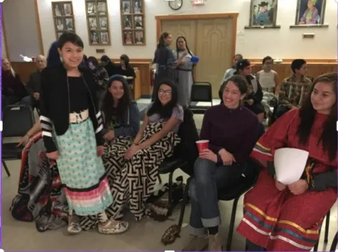 Students at an event smiling at the camera 