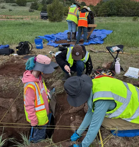 People excavating at an archaeological dig site.