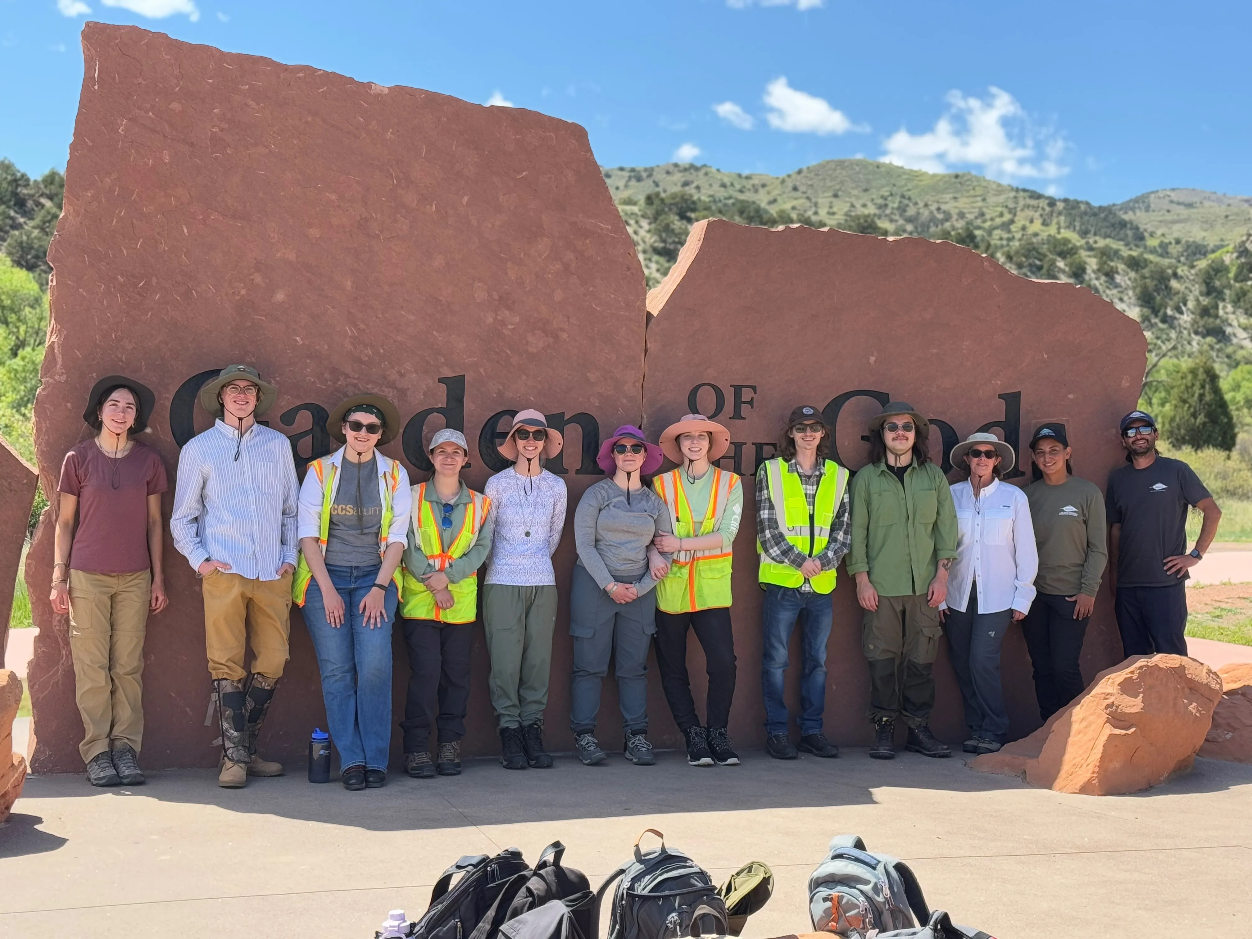 Group of people standing in front of "garden of the Gods" sign